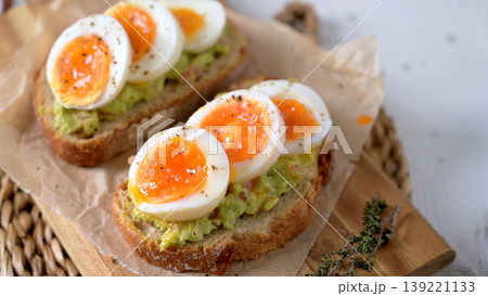 Soft Boiled Eggs on Smashed Avocado Toast with Black Pepper and Herbs Soft Boiled Eggs on Smashed Avocado Toast with Black Pepper and Herbs 139221133