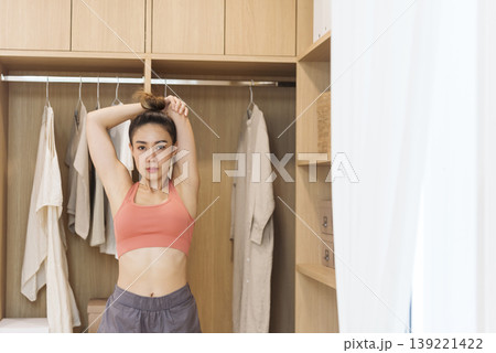 Sport Women home fitness workout exercise in living room healthy lifestyle. Asian Young woman wear wellness sportswear arms stretching firm body workout slim slender. Healthy wellness woman concept Sport Women home fitness workout exercise in living room healthy lifestyle. Asian Young woman wear wellness sportswear arms stretching firm body workout slim slender. Healthy wellness woman concept 139221422