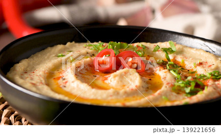 Delicious hummus in ceramic bowl 139221656