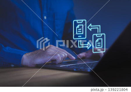 Data transfer and file sharing concept. Hand using laptop with neon mobile sync icon. Digital document exchange, technology communication, internet connection and business transformation. 139221804