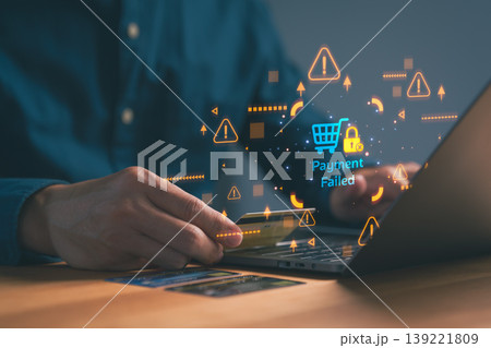 Man using credit card for online shopping with payment failed message. Business e-commerce transaction error and security alert on computer screen. Man using credit card for online shopping with payment failed message. Business e-commerce transaction error and security alert on computer screen. 139221809