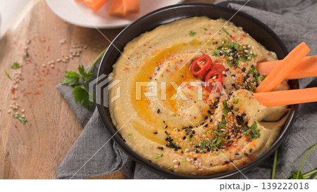 Creamy Hummus Bowl Topped with Olive Oil Chili and Sesame Seeds Creamy Hummus Bowl Topped with Olive Oil Chili and Sesame Seeds 139222018