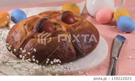Traditional Tsoureki Greek Easter Bread with Red Dyed Eggs and Colorful Decorations 139222023