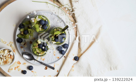 Top View of Chia Seed Pudding with Kiwi and Blueberries in Glass Jars Top View of Chia Seed Pudding with Kiwi and Blueberries in Glass Jars 139222024