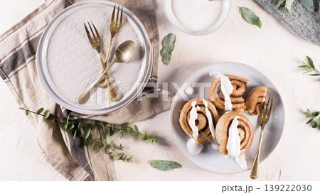 Top Down View of Fresh Cinnamon Rolls with Icing on White Plates Top Down View of Fresh Cinnamon Rolls with Icing on White Plates 139222030