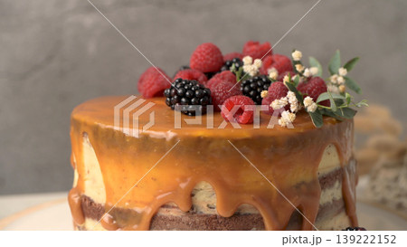 Layered Chocolate Cake with Caramel Drip Topped with Fresh Raspberries and Blackberries Layered Chocolate Cake with Caramel Drip Topped with Fresh Raspberries and Blackberries 139222152