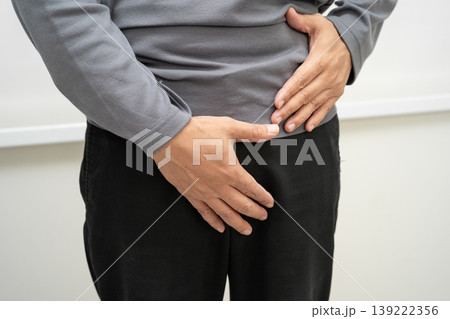 Hernia, Asian man stomach ache, abdominal pain and urology problem health. 139222356