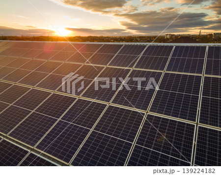 Photovoltaic panels on solar rooftops of commercial building for producing clean ecological electrical energy. Renewable electricity with zero emission concept. Photovoltaic panels on solar rooftops of commercial building for producing clean ecological electrical energy. Renewable electricity with zero emission concept. 139224182