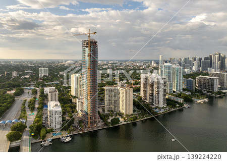 New construction site in Miami, Florida. Developing residence in American urban area. Concept of housing growth in the USA New construction site in Miami, Florida. Developing residence in American urban area. Concept of housing growth in the USA 139224220