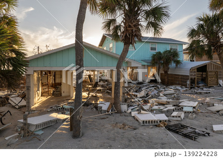 Natural disaster and its consequences. Hurricane destroyed houses roof and walls in Florida coastal area Natural disaster and its consequences. Hurricane destroyed houses roof and walls in Florida coastal area 139224228