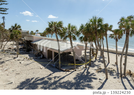 Natural disaster and its consequences. Hurricane destroyed houses roof and walls in Florida coastal area Natural disaster and its consequences. Hurricane destroyed houses roof and walls in Florida coastal area 139224230