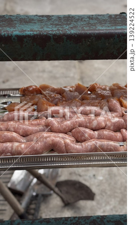 Assorted raw meats ready for grilling outdoors. Assorted raw meats ready for grilling outdoors. 139224522