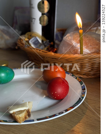 A festive scene featuring decorated eggs and a candle. 139224527