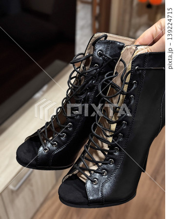 Elegant black high heels with lace-up design, perfect for chic outfits. 139224715