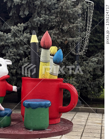 Whimsical oversized art tools create a vibrant playground atmosphere. Whimsical oversized art tools create a vibrant playground atmosphere. 139224717