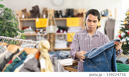 In chain shop, Indonesian man choose jeans, X mas shopping 139224738