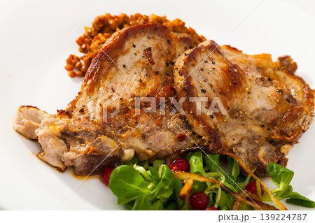 Grilled pork meat with lentils, cornsalad and red currant 139224787