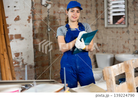 Portrait of woman builder standing in construction site Portrait of woman builder standing in construction site 139224790