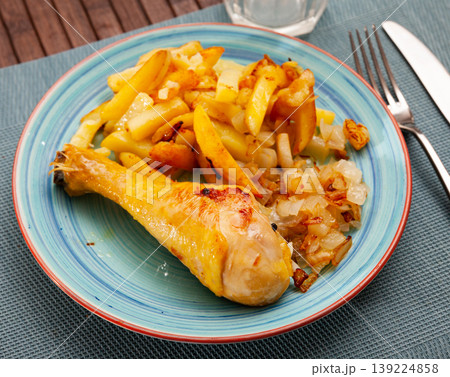 Tasty baked chicken potatoes and zucchini at plate 139224858