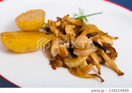 Fried oyster mushrooms with potatoes 139224889