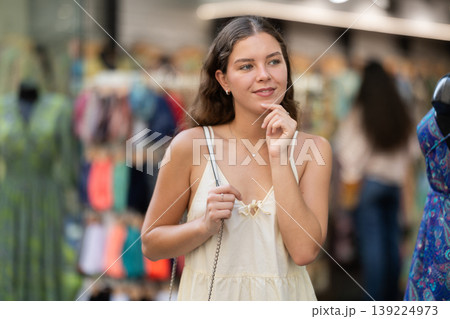 Young woman looks around at street market 139224973