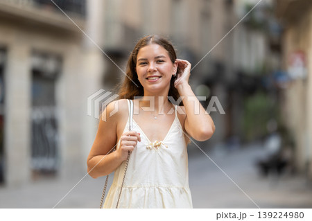 Young woman posing on city street 139224980