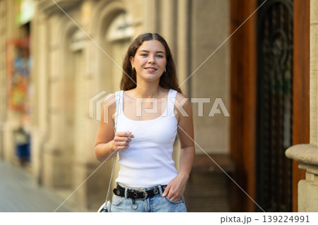 Young girl enjoying walk along summer city stree 139224991