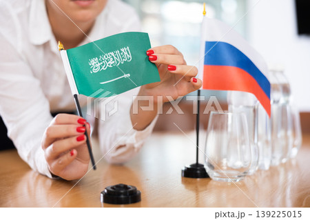 Flags of Saudi Arabia and Russia stand on negotiating table in office Flags of Saudi Arabia and Russia stand on negotiating table in office 139225015