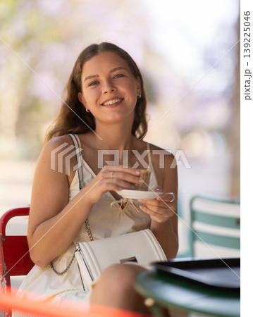 Young woman drinking coffee in cafe 139225046
