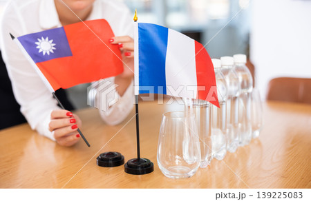 Flags of Taiwan and France stand on negotiating table in office 139225083