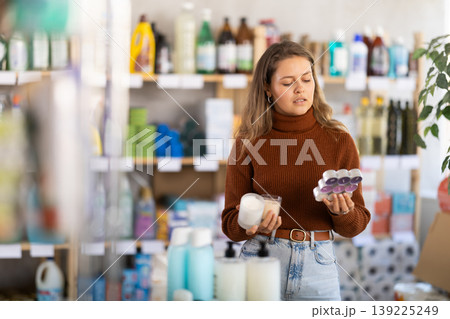 Young woman choosing scented candles in store 139225249