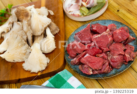 Pieces of raw veal with oyster mushrooms Pieces of raw veal with oyster mushrooms 139225319