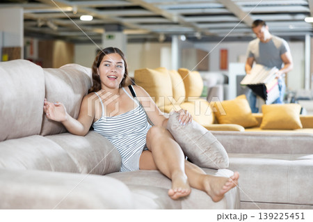 Female customer choosing comfortable lounge furniture in store 139225451