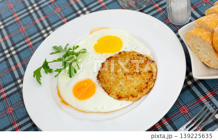 On plate are marrow squash pancakes with fried eggs 139225635