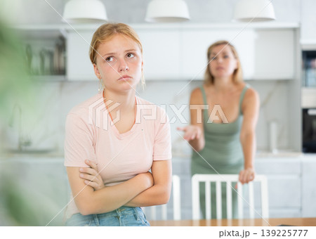 Angry mother yells at teenage girl sad daughter Angry mother yells at teenage girl sad daughter 139225777