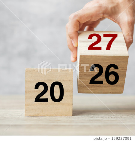 hand flipping block 2026 to 2027  text on table. Resolution, strategy, plan, goal, motivation, reboot, business and New Year holiday concepts 139227091