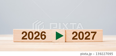 2026 and 2027 wooden block on table background. Resolution, strategy, countdown, goal, change and New Year holiday concepts 2026 and 2027 wooden block on table background. Resolution, strategy, countdown, goal, change and New Year holiday concepts 139227095