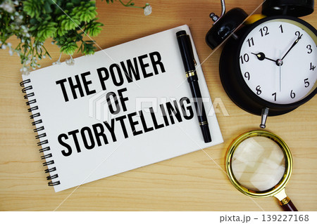 The Power Of Storytelling text written on notepad with alarm clock and magnifying glass flat lay on wooden background 139227168
