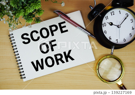 Scope Of Work text written on notepad with alarm clock and magnifying glass flat lay on wooden background 139227169