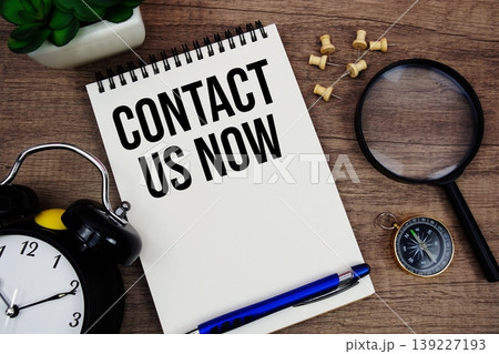 Contact Us Now text written on notepad with...の写真素材 [139227193] - PIXTA