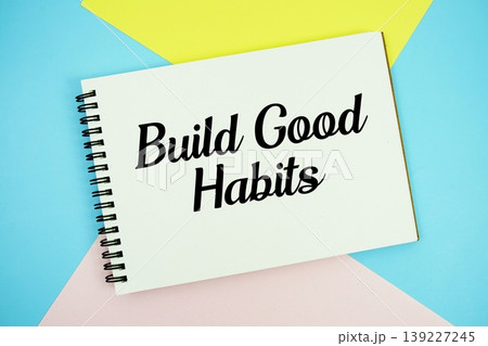 Build Good Habits text written on notepad flat lay on multicolor pastel background 139227245
