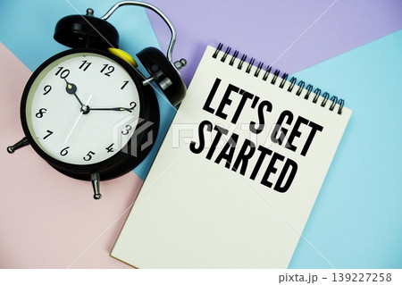 Let's Get Started text written on notepad with alarm clock flat lay on multicolor pastel background Let's Get Started text written on notepad with alarm clock flat lay on multicolor pastel background 139227258