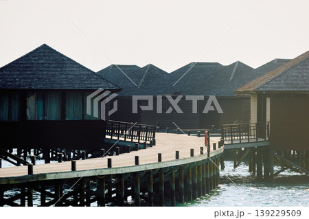 Breathtaking view of overwater bungalows resort on tropical turquoise lagoon Maldives island, sunset light, popular tourist destination, exotic 139229509