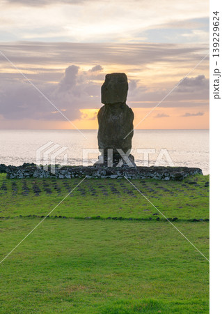 Solemn ancient moai statue stands on easter island chile during peaceful sunset Solemn ancient moai statue stands on easter island chile during peaceful sunset 139229624