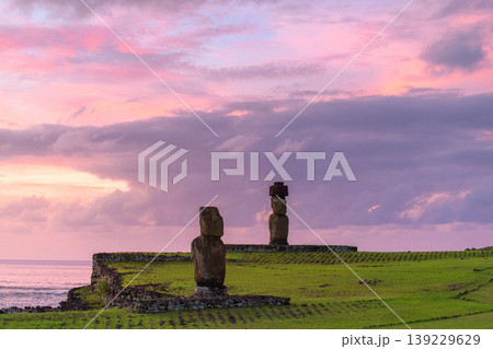 Majestic moai statue watches serene sunset over easter island chile Majestic moai statue watches serene sunset over easter island chile 139229629