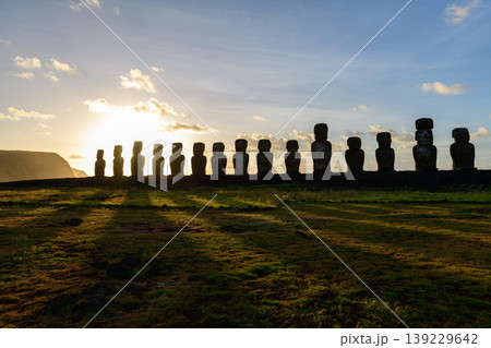 Peaceful moai statue standing in easter island chile during sunset Peaceful moai statue standing in easter island chile during sunset 139229642