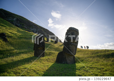 Majestic and solemn moai statue standing on green hill in easter island chile Majestic and solemn moai statue standing on green hill in easter island chile 139229647