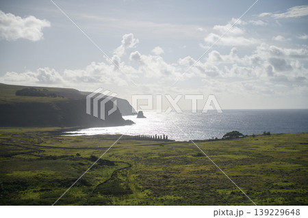 Serene easter island chile coastline view with grassy cliff and bright ocean Serene easter island chile coastline view with grassy cliff and bright ocean 139229648