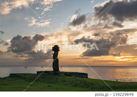 Majestic peaceful moai statue standing on easter island chile at sunset Majestic peaceful moai statue standing on easter island chile at sunset 139229649