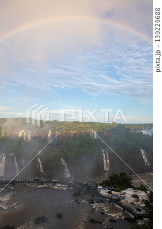 Majestic rainbow arching over peaceful mist of iguazu falls river landscape Majestic rainbow arching over peaceful mist of iguazu falls river landscape 139229688